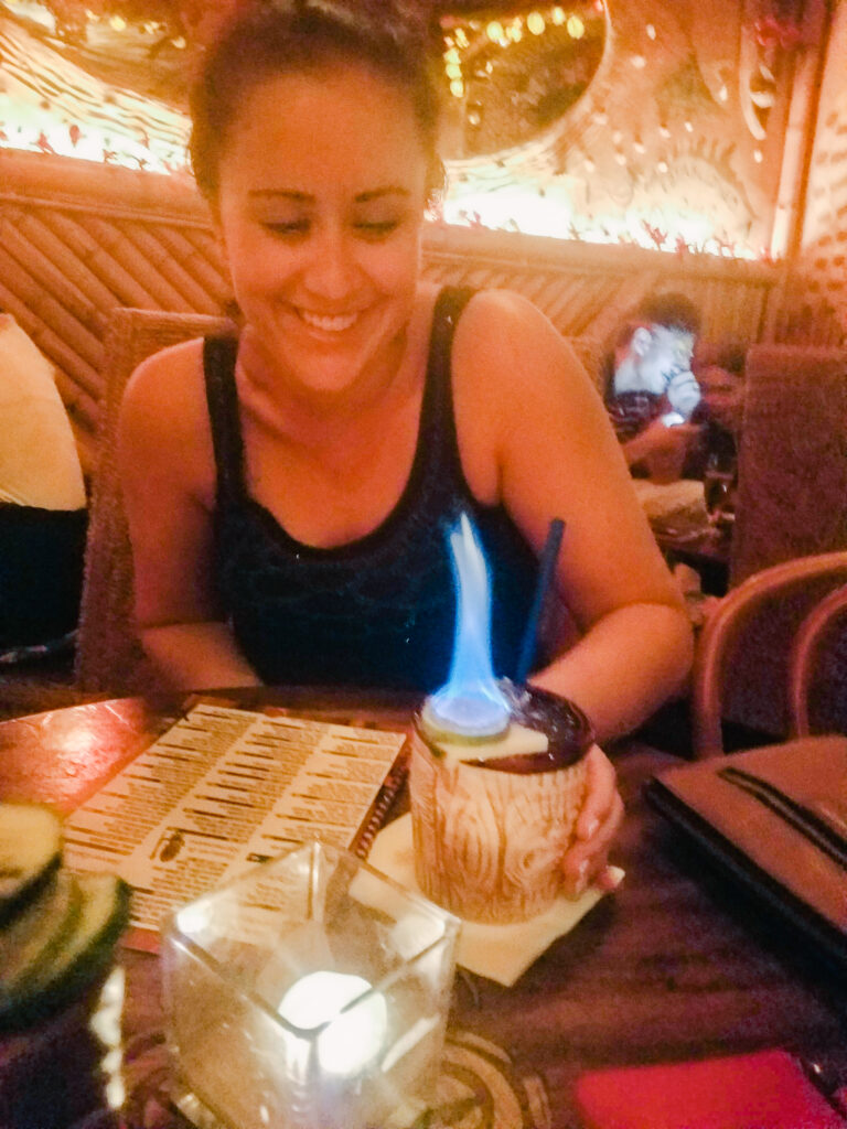 A girl with a flaming drink at a bar in Prague's Zizkov District (visiting this area is one of the most interesting things to do in Prague).