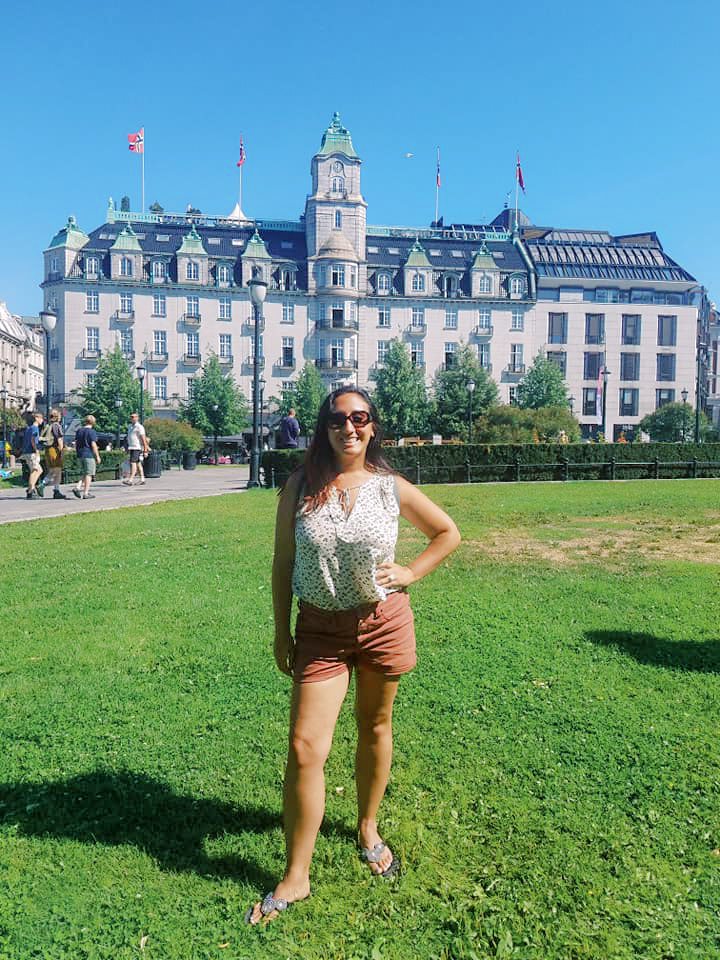 A woman stands against a backdrop of the Nobel Peace Center in Oslo