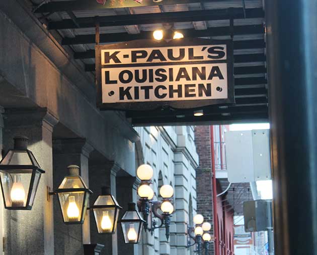 A hanging sign advertising K-Paul's Louisiana Kitchen in New Orleans.
