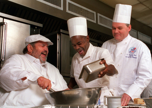 Three chefs cooking in K-Paul's Louisiana Kitchen.