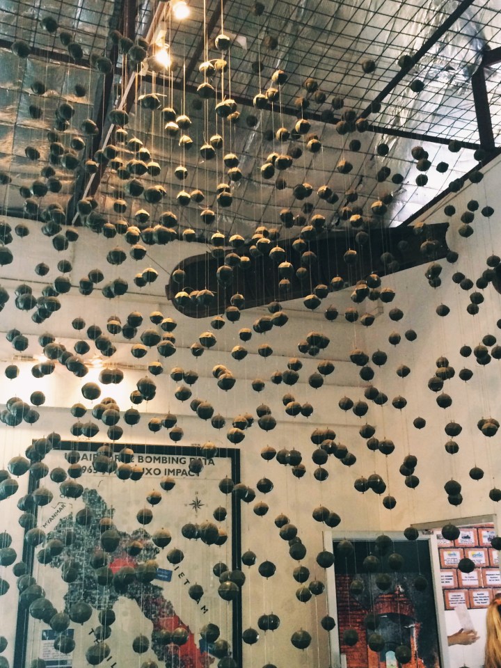 An exhibit at the COPE Center displaying model cluster bombs hanging from the ceiling