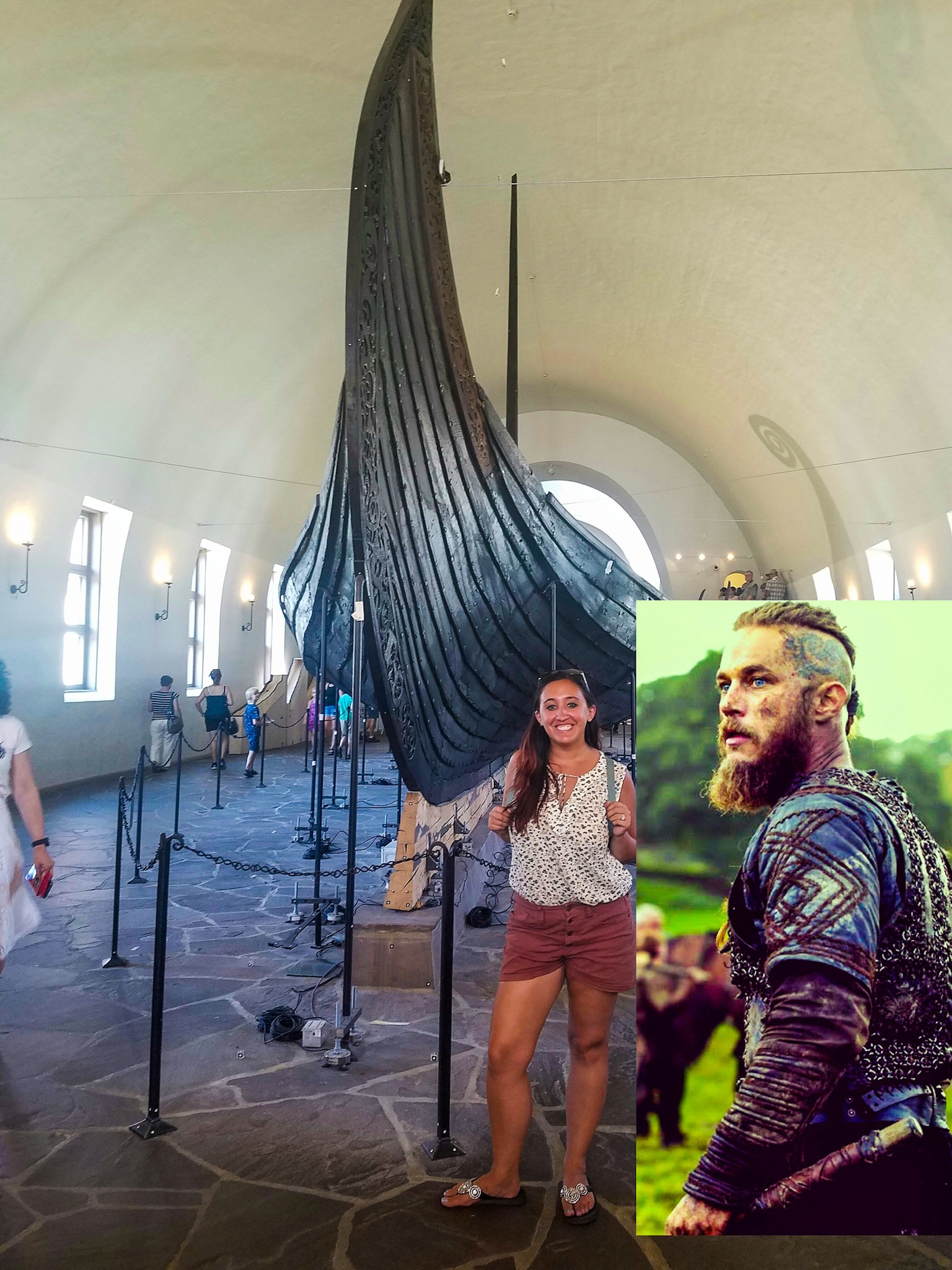 A woman poses next to an excavated Viking ship in a museum in Oslo, next to a photo of a character from the Vikings TV show