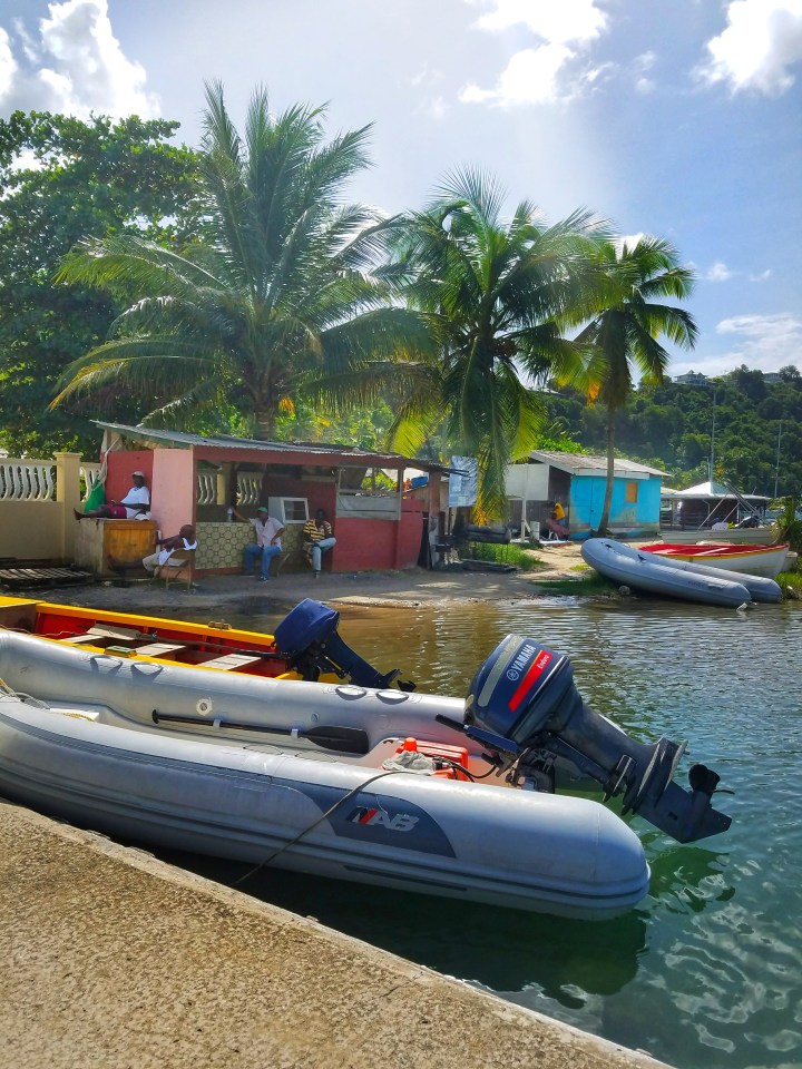 Several boats and small shacks on the shore in St Lucia