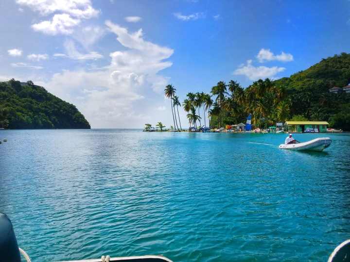 Blue sky and blue water with a boat in the background in St Lucia