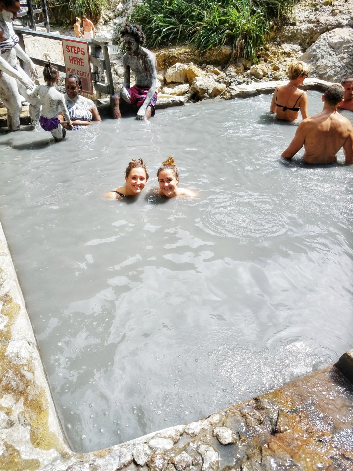 The sulfur springs are featured here as well as some people enjoying them, they are a relaxing way to spend one day in Soufriere. 