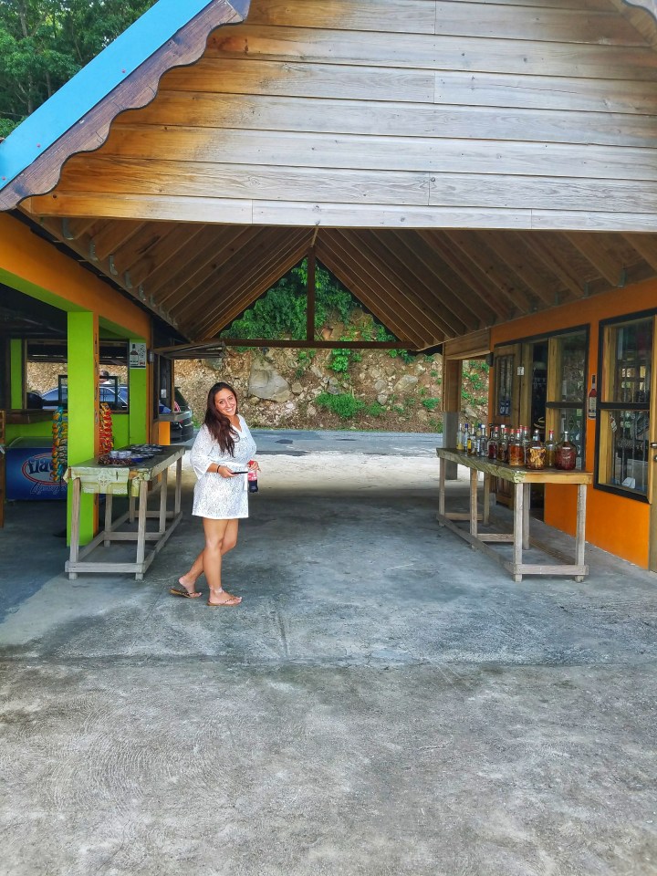 Author smiles at camera as she embarks on rum tasting during her one day in Soufriere. 