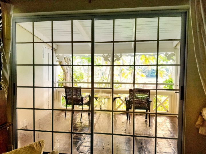 A beautiful deck attached to a hotel room through a sliding glass door. It's the perfect place to sit and listen to music during a trip to St Lucia with a friend