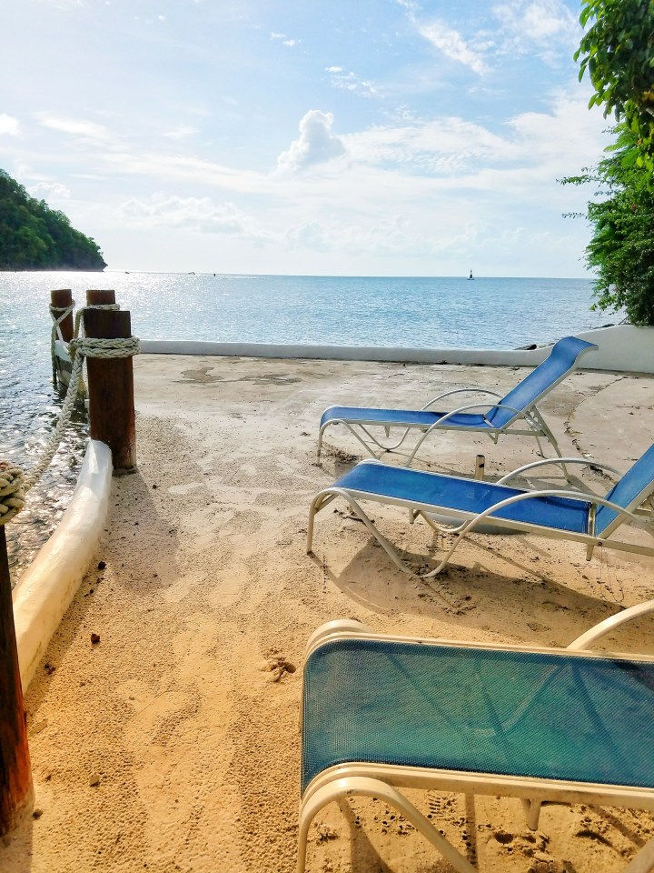 Three blue lounge chairs in the sand overlooking Marigot Bay. This was the perfect place to have many girl chats on my trip to St Lucia with a friend. 