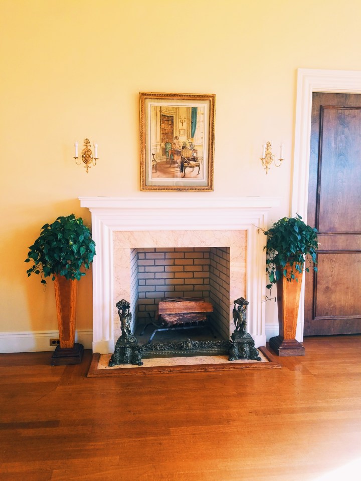 Fire place with picture hanging over it at Oheka Castle on Long Island, one of the inspirations used for Gatsby's mansion