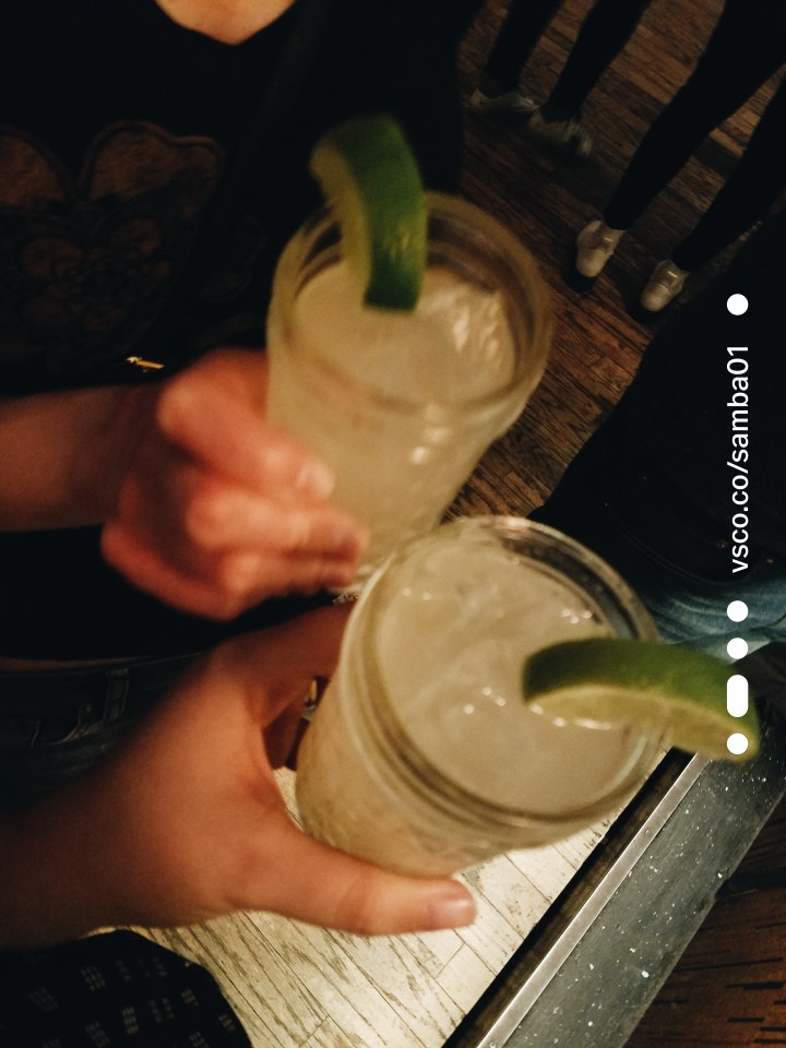 Two Moscow mule drinks with limes on the edge of the glass. 