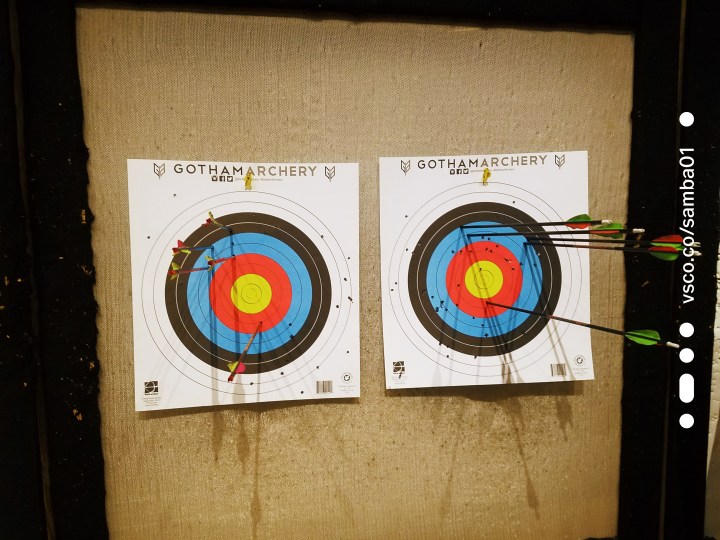 two archery targets with bows inside of the targets at Gotham Archery