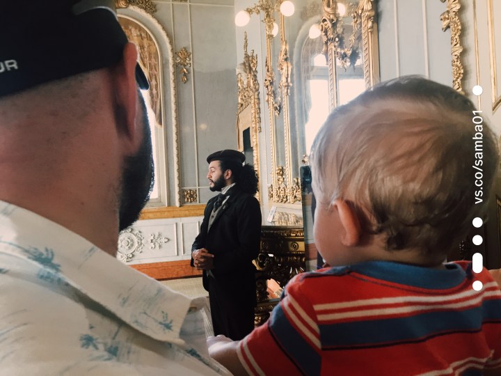 A man and child at a tour of the National Theater in San Jose