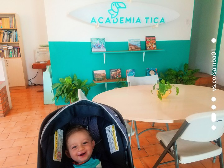 A child smiling in a stroller