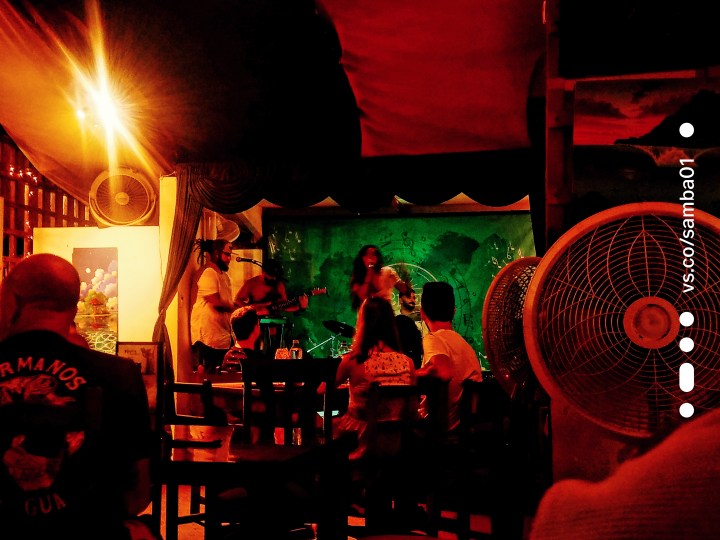 A singer is performing on stage at the Green Room in Jaco Costa Rica