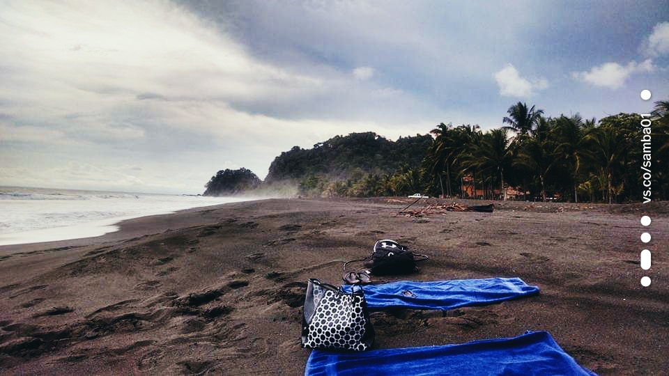 Two blankets spread out on the sand on a beach in Jaco, Costa Rica