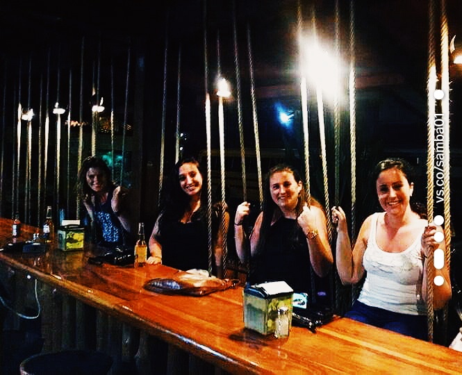 Four women sitting at a bar having drinks