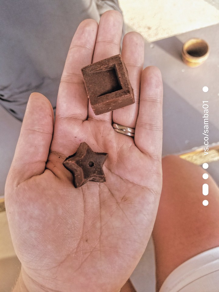 Two pieces of chocolate, one shaped like a square and the other like a star