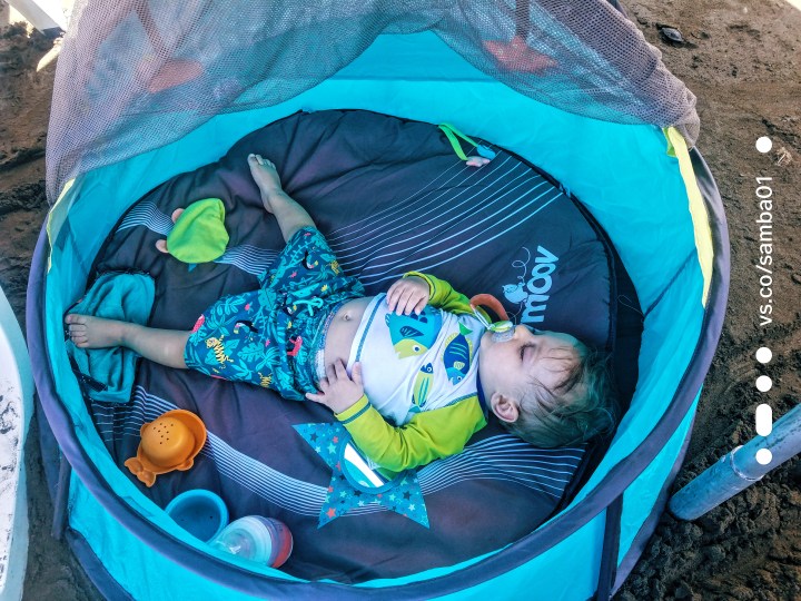 A child asleep on the beach