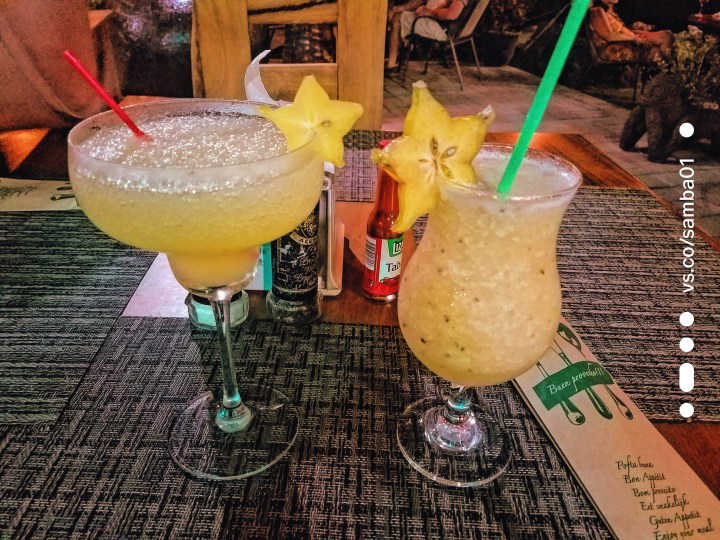 Two drinks decorated with starfruit