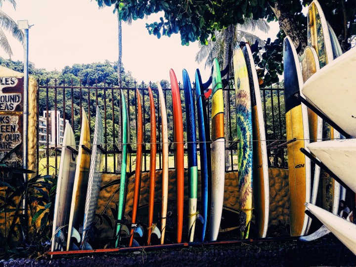 A rack holding different sizes of surfboards