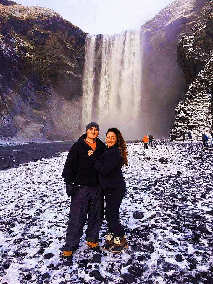 A couple in front of Skogafoss waterfall 