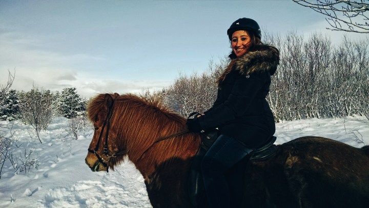 A woman riding an Icelandic horse in Iceland