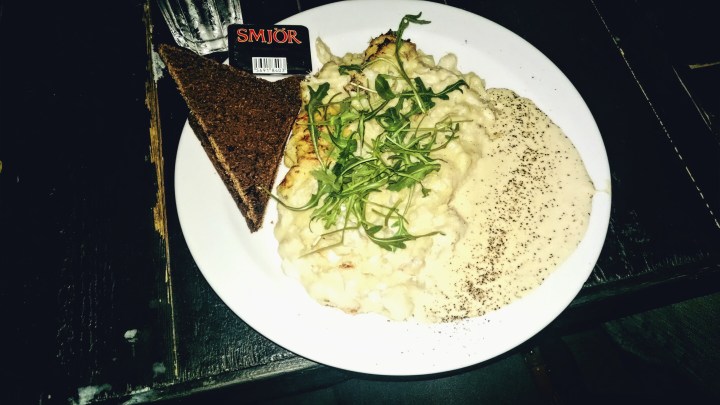 Thick, Icelandic fish chowder served on a plate instead of a bowl with a side of brown bread. 