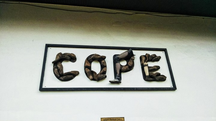 A sign reading "COPE" made of prosthetic welcomes visitors to the COPE center. 