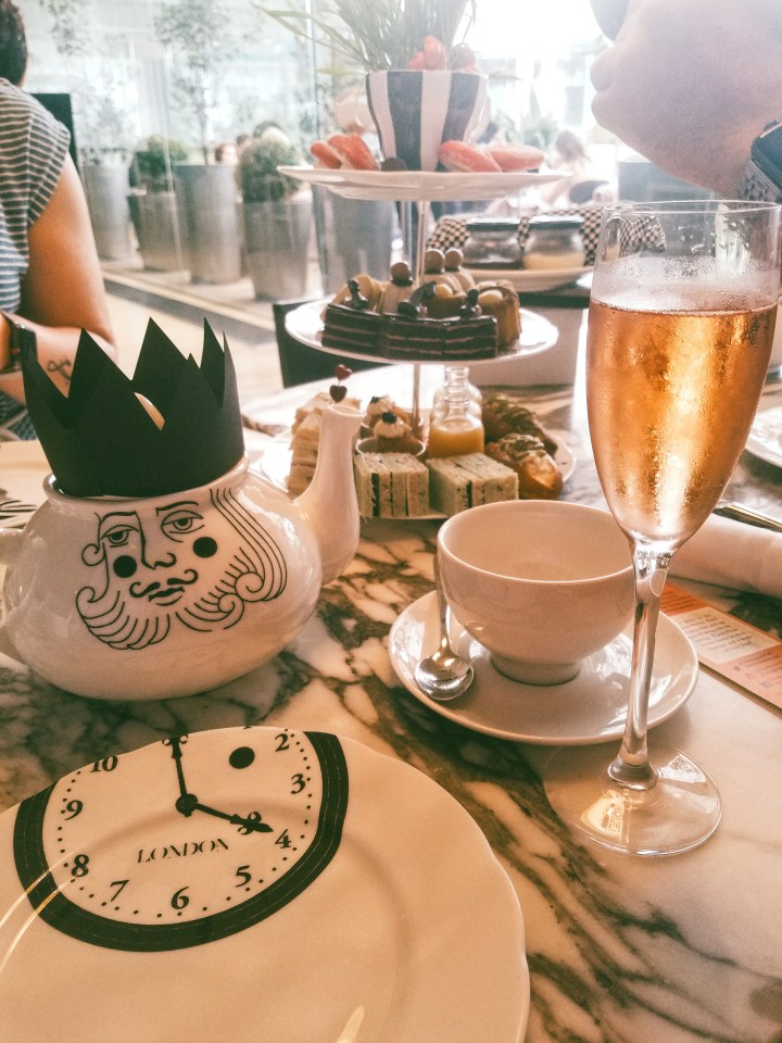 A glass of rose champagne accompanies tea and treats at the Sanderson hotel's Mad Hatter Afternoon Tea in London