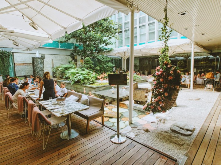 A photo of the outdoor garden section of the Sanderson hotel's Mad Hatter Afternoon Tea in London. 