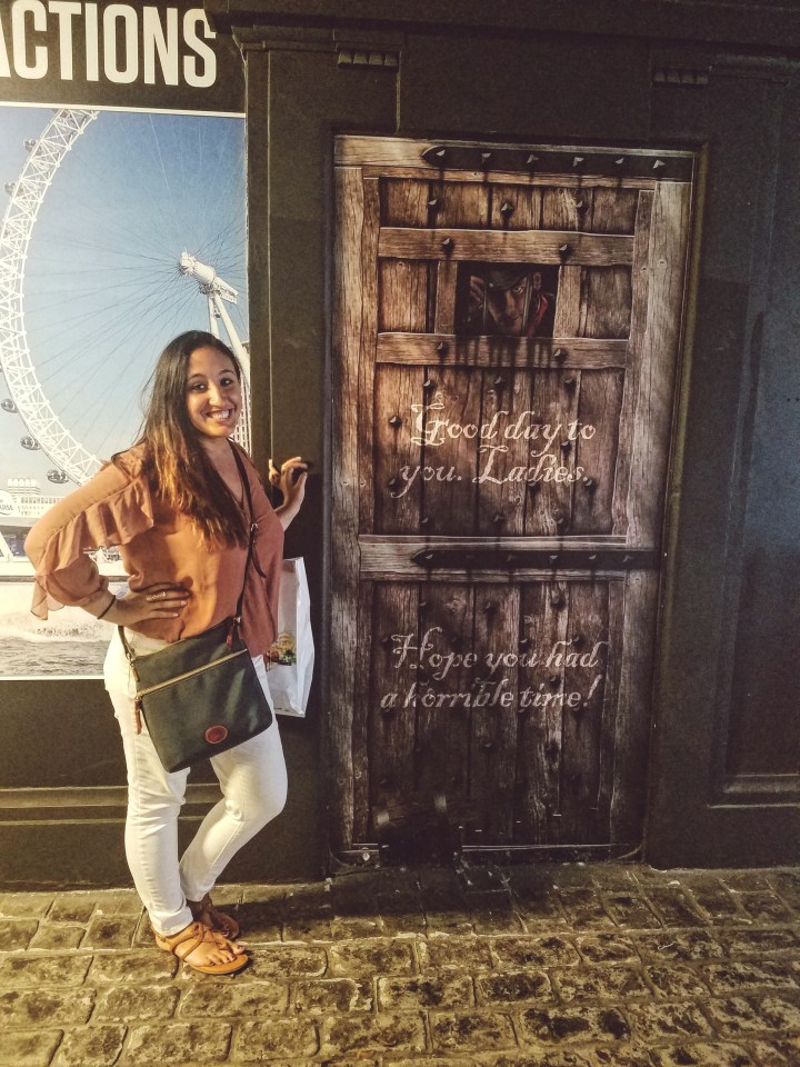 Posing with the exit sign at the London Dungeon. Check it out during your first time in London.