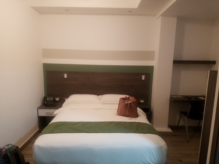 Writer is showing the hotel room that she rented which has plenty of space for her family of three.