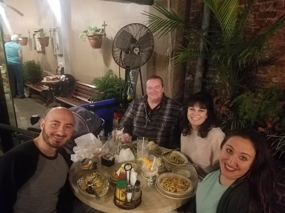 A group of four people sit around a table at The Gumbo Shop