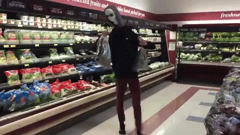 A gif of someone dancing in a grocery store