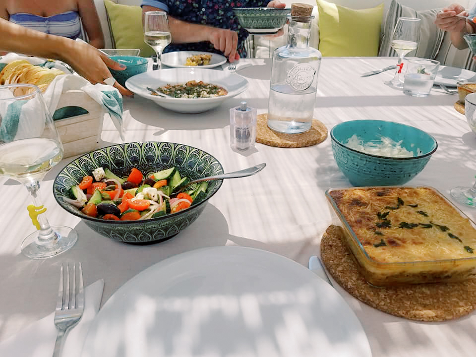 A table with a spread of Greek foods
