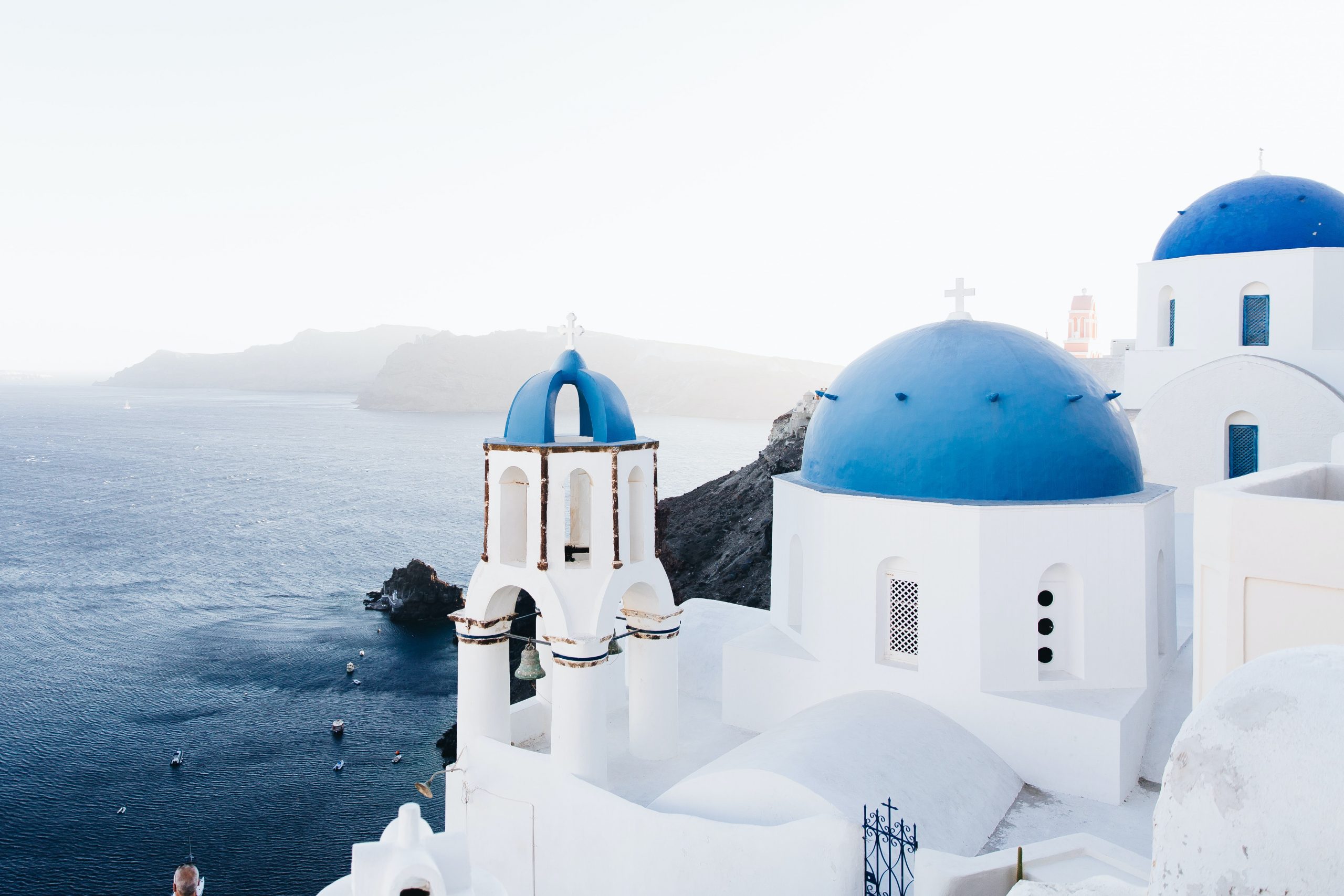 White buildings with blue roofs overlooking the ocean in Santorini