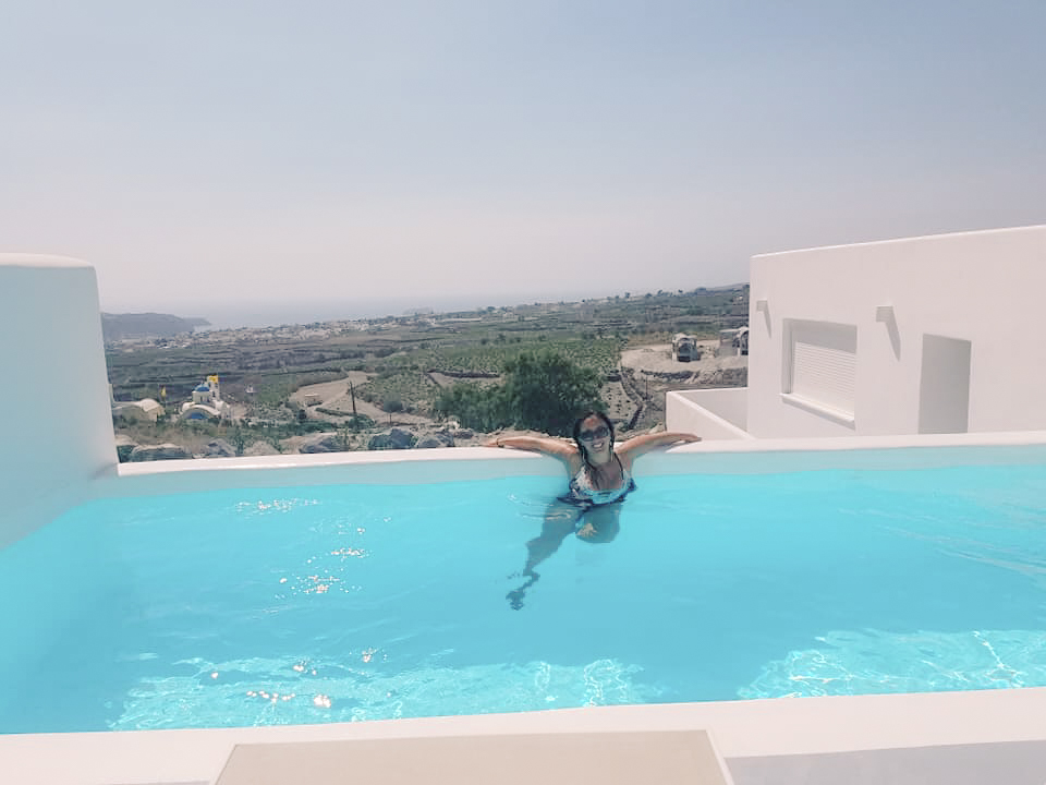 A woman in an pool in Santorini