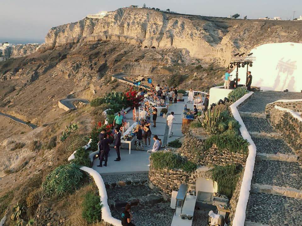 A crowed gathered at a winery for a wedding in Santorini