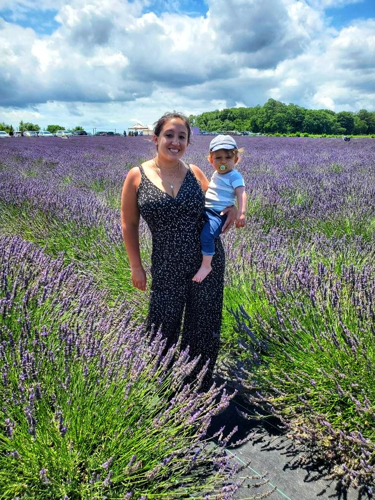 A woman and a child pose in the middle of a lavender field at Lavender by the Bay