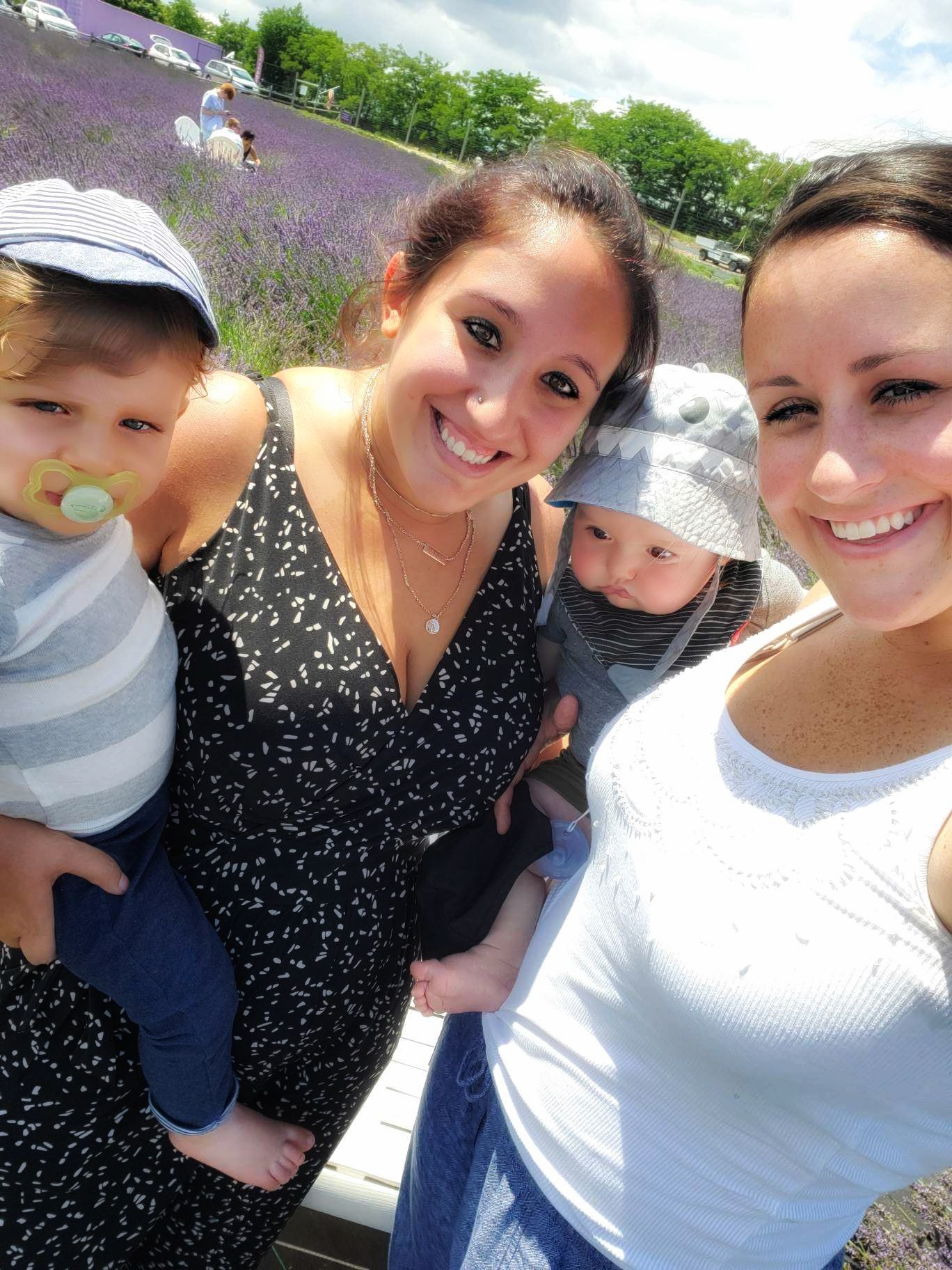 Two women and two children standing in a lavender field