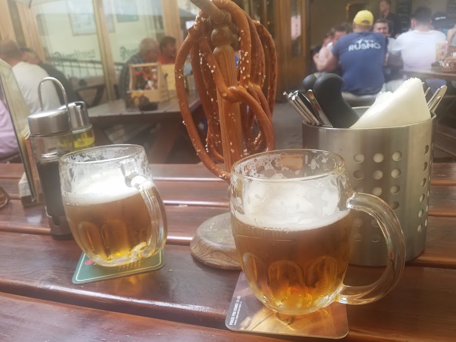 Two mugs of beer served in a restaurant in Prague