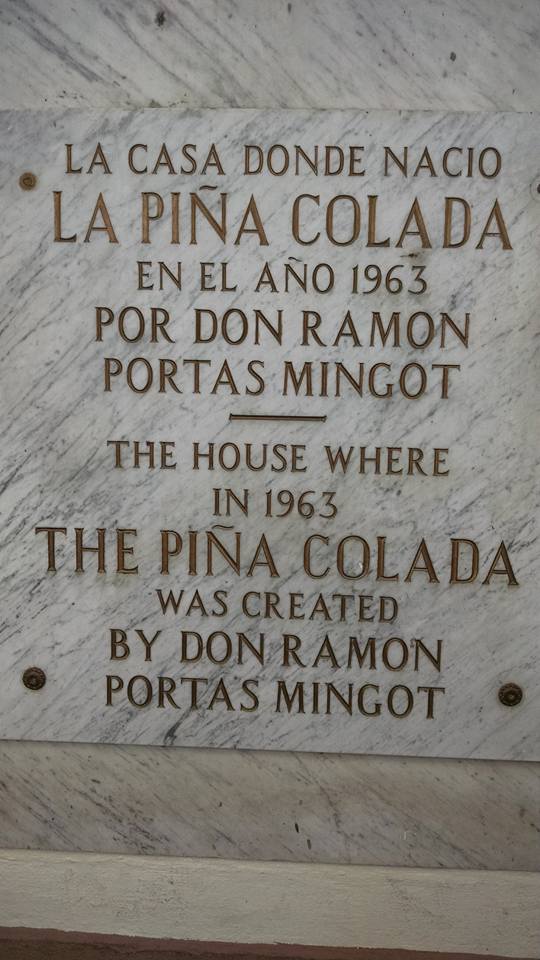 A sign with text describing the place of origin of the first pina colada