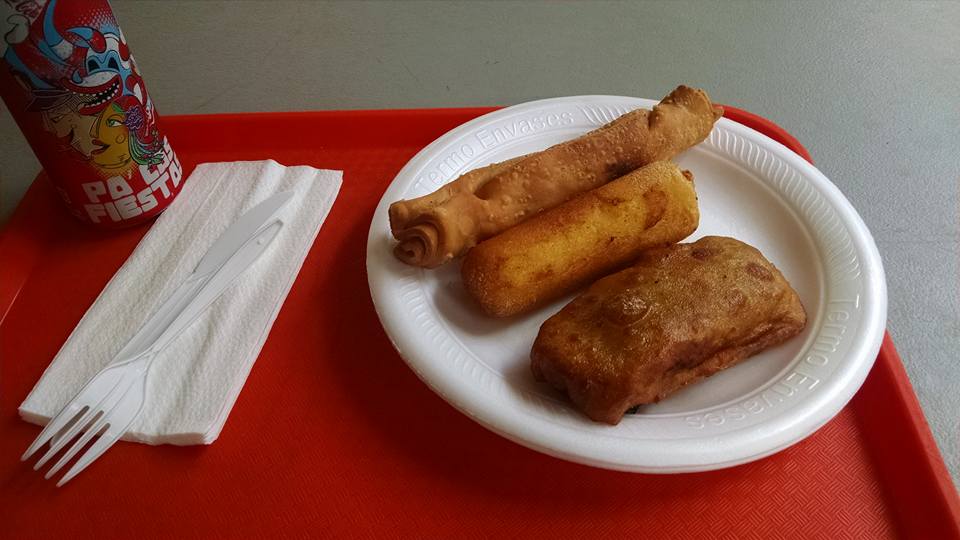 A plate of pinchos on a red tray