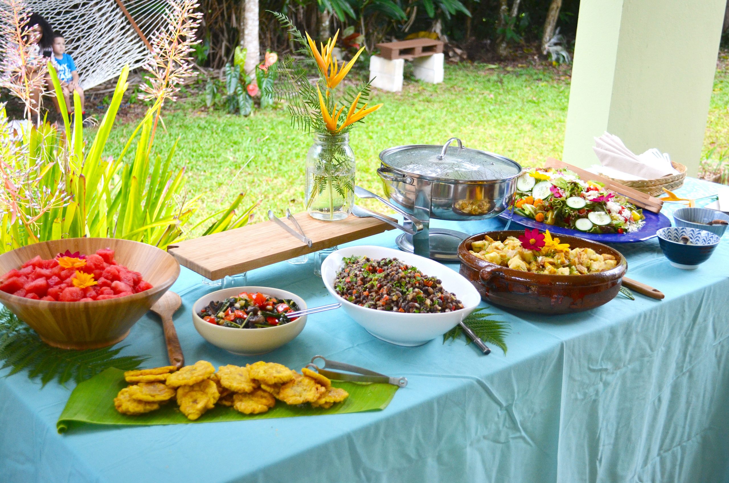 A table spread with various dishes filled with food