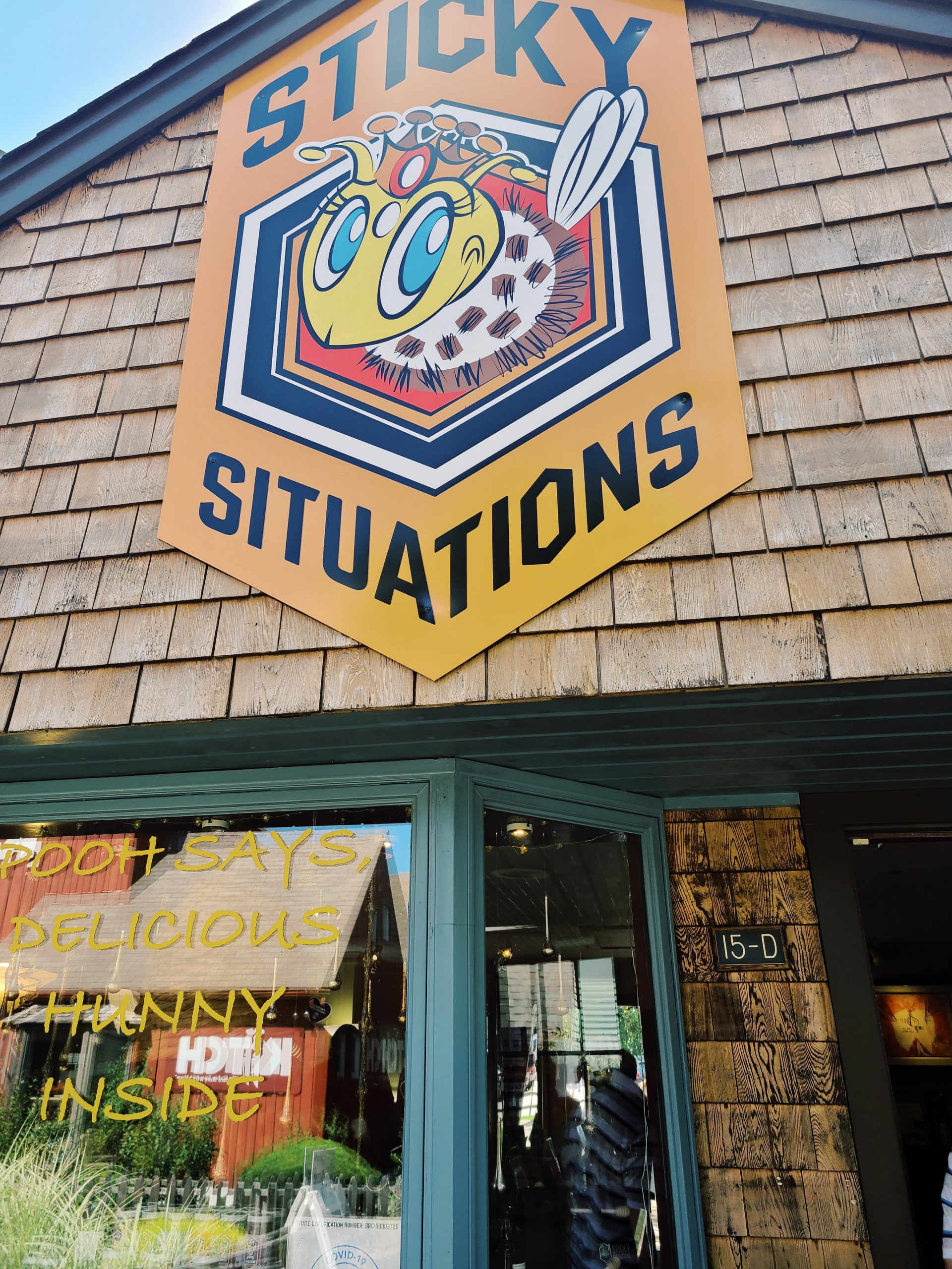 A photo of the outside of a honey shop called "Sticky Situations" in Mystic, Connecticut