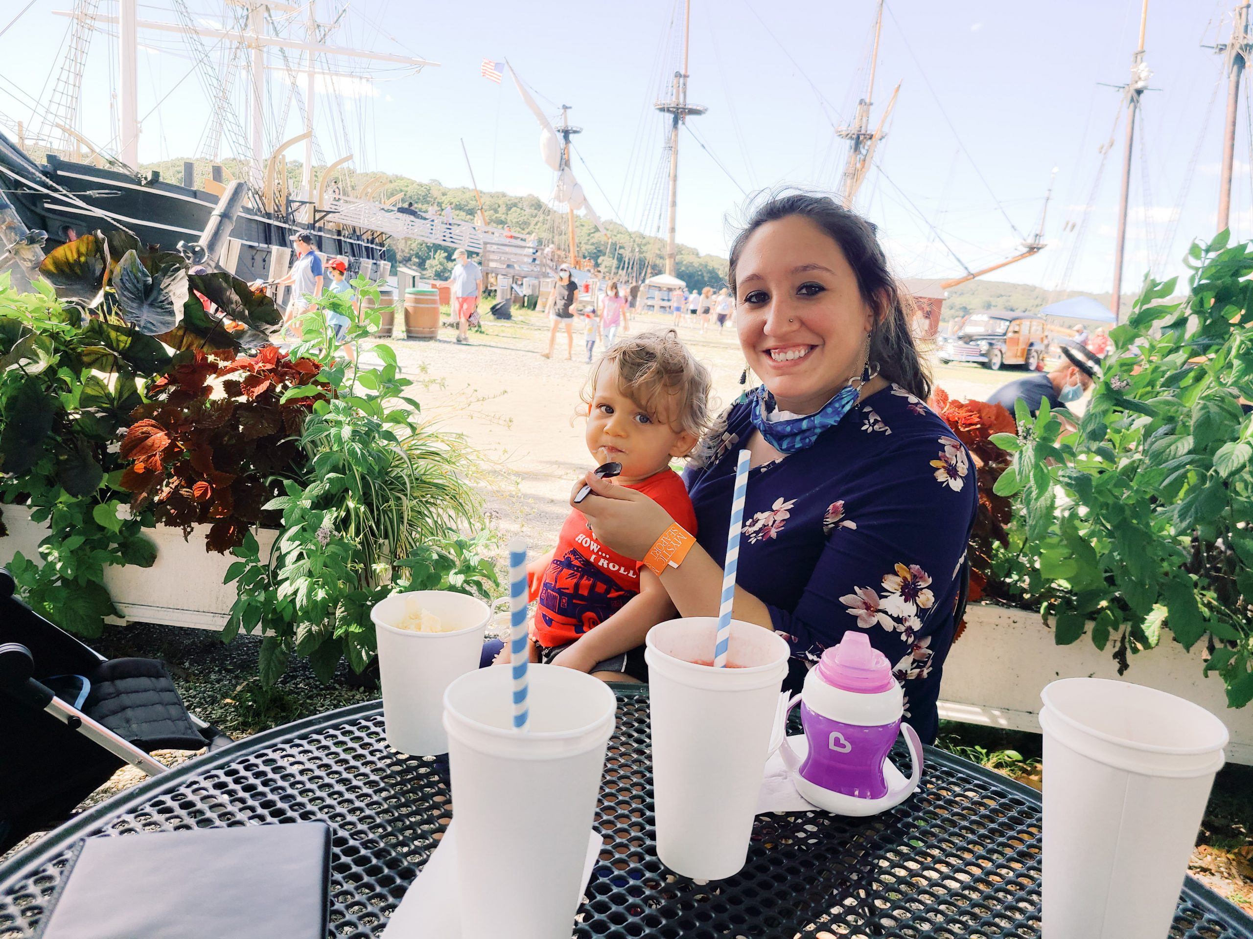 A woman and child sit at a table enjoying beverages at the Seasport Museum