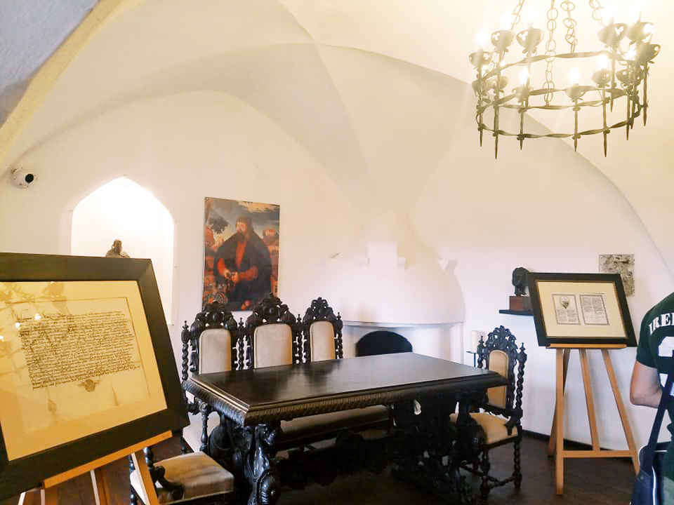 A table and other artifacts on display inside Bran Castle