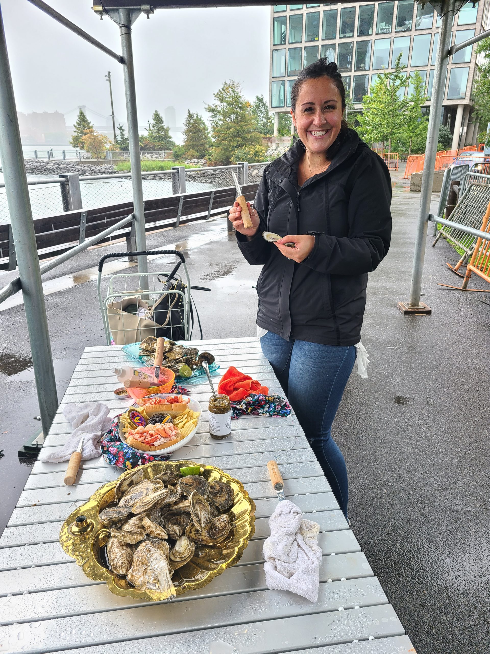 A woman poses while shucking an oyster