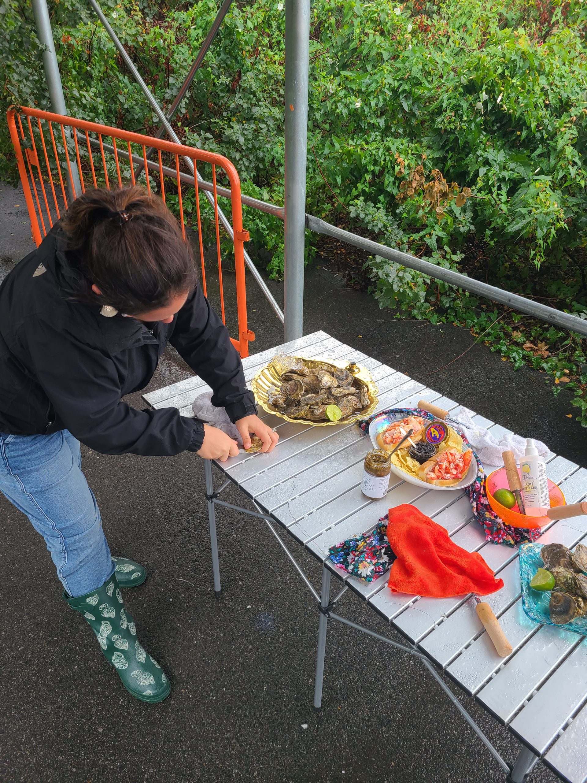 A woman shucking an oyster