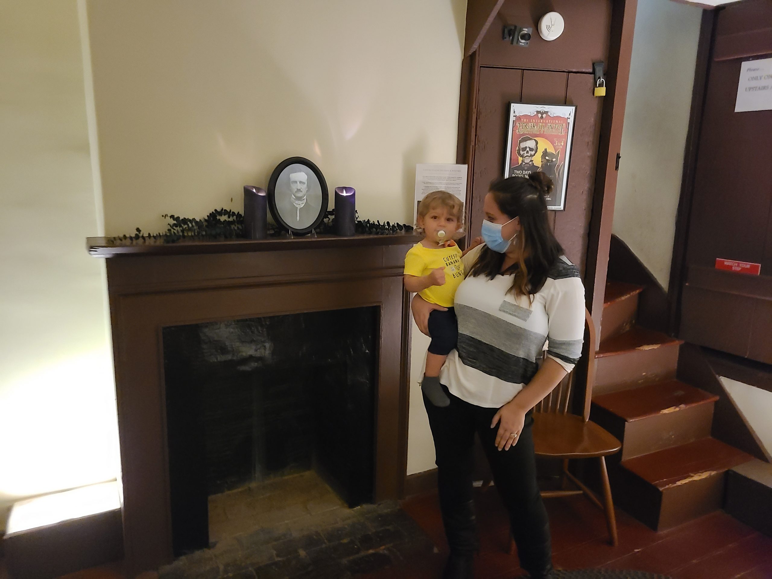 A woman and child standing in the Edgar Allan Poe house